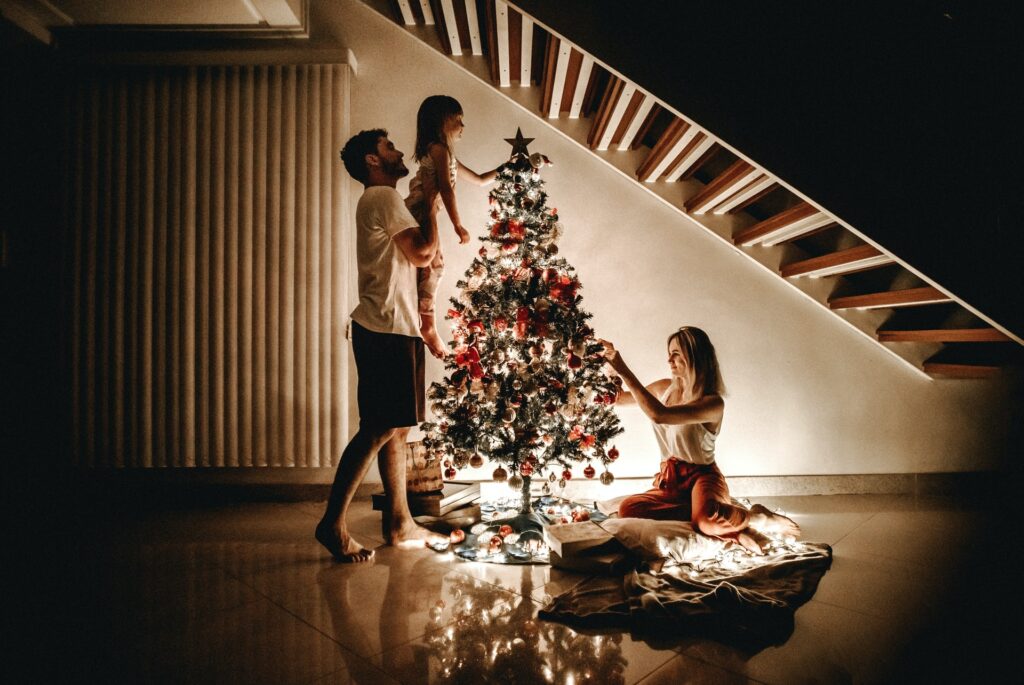 Family decorating a Christmas tree in Brazil.