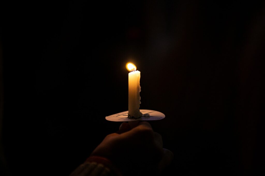 Image of a person holding a candle to exemplify the Brazilian idiom.